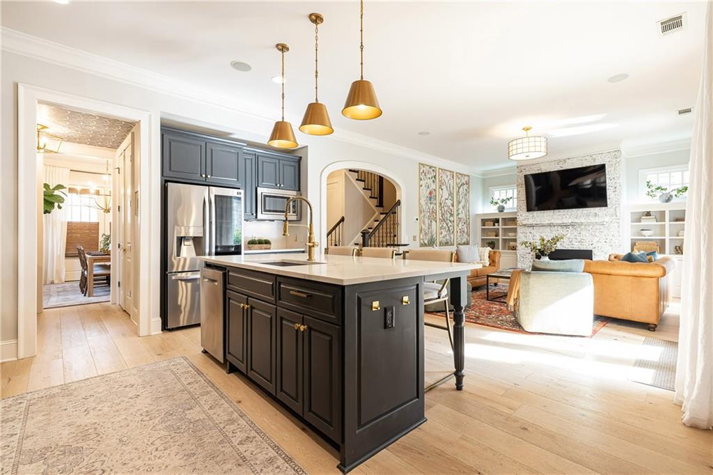 6810 Lullwater Road Cumming, GA 30040 - Photo 17 of 63 a kitchen with stainless steel appliances granite countertop a stove and a sink