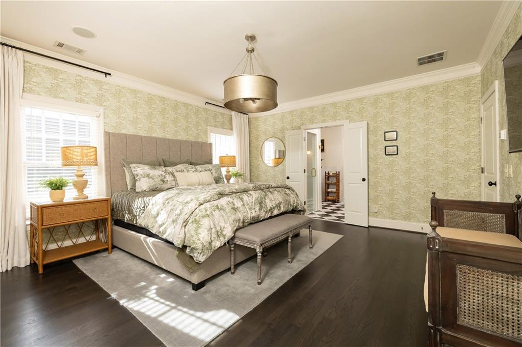 6810 Lullwater Road Cumming, GA 30040 - Photo 26 of 63 a bedroom with a bed and a chandelier