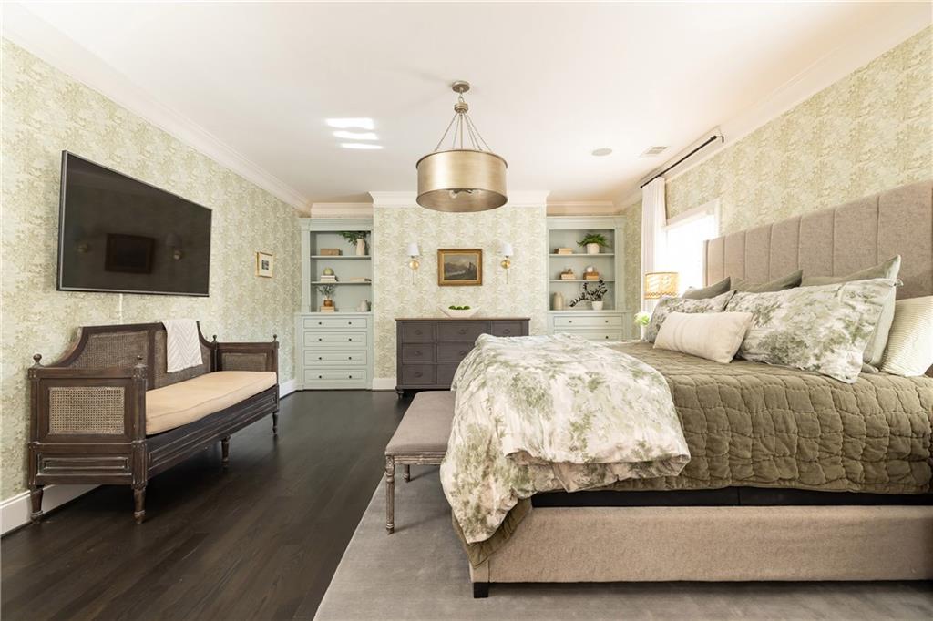 6810 Lullwater Road Cumming, GA 30040 - Photo 27 of 63 a spacious bedroom with a bed and flat screen tv