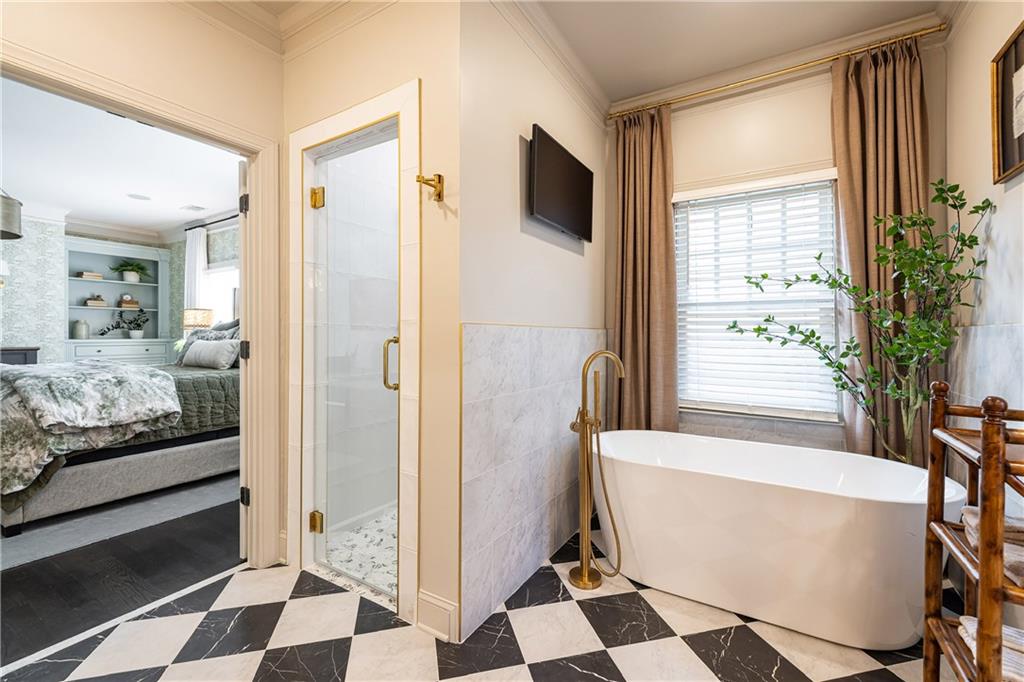 6810 Lullwater Road Cumming, GA 30040 - Photo 29 of 63 a bathroom with a bathtub and a shower