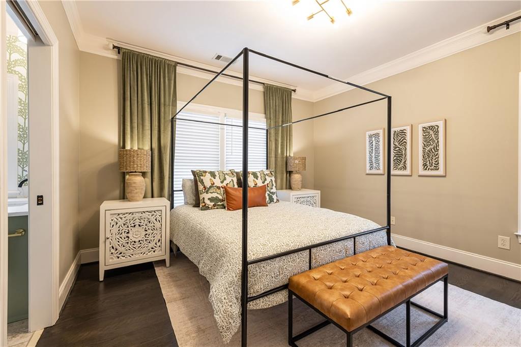 6810 Lullwater Road Cumming, GA 30040 - Photo 38 of 63 a bedroom with a bed and a table in it