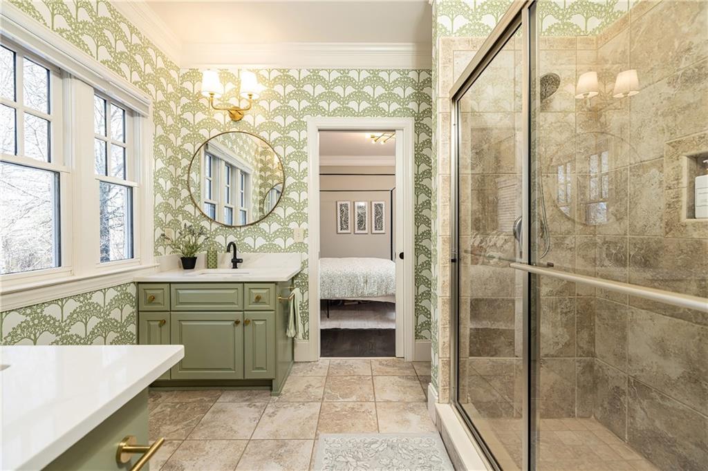 6810 Lullwater Road Cumming, GA 30040 - Photo 39 of 63 a bathroom with a tub sink shower and mirror