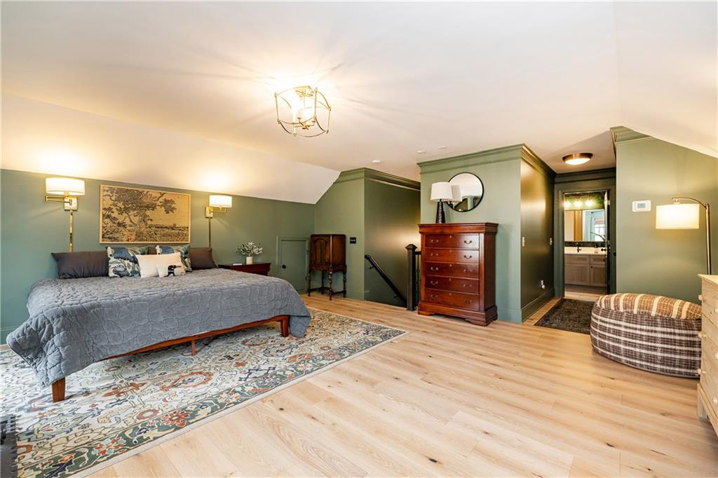 6810 Lullwater Road Cumming, GA 30040 - Photo 42 of 63 a bedroom with a large bed and a chandelier