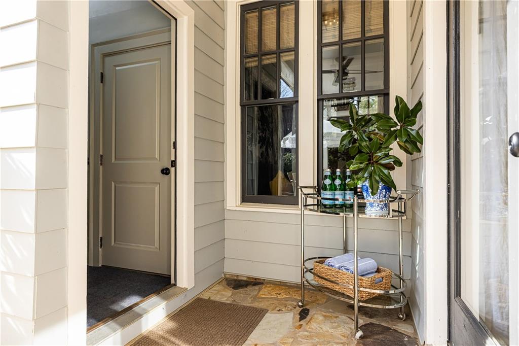 6810 Lullwater Road Cumming, GA 30040 - Photo 44 of 63 a backyard of a house with a glass door and furniture