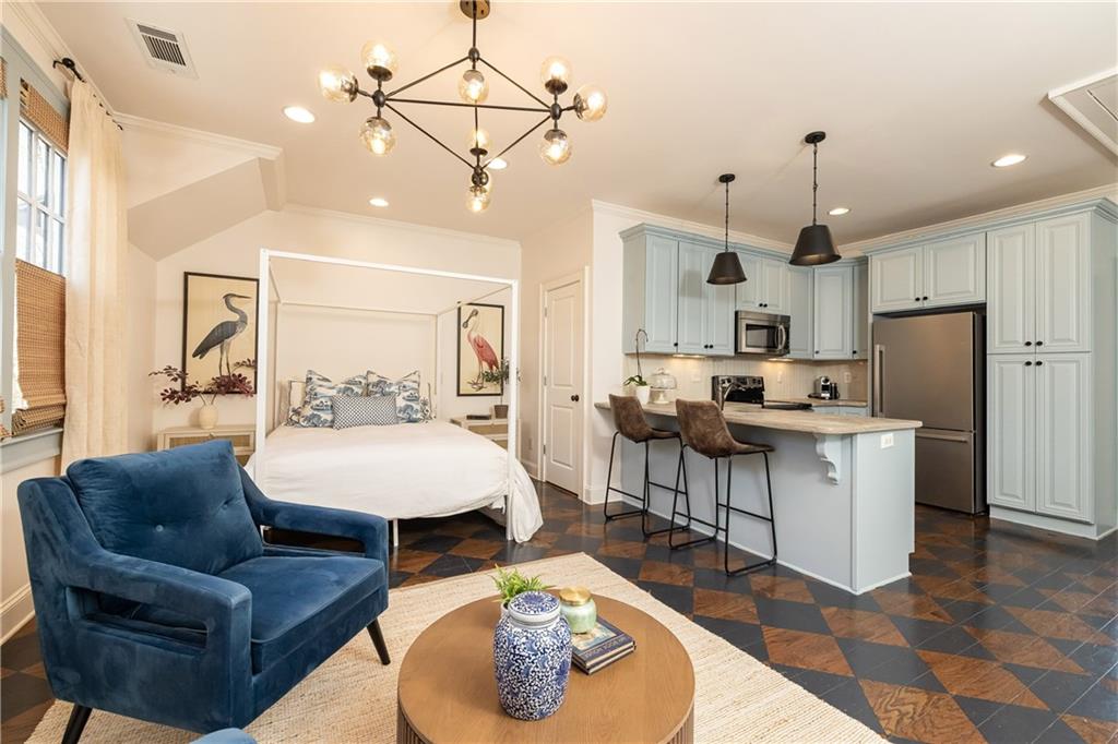 6810 Lullwater Road Cumming, GA 30040 - Photo 46 of 63 a living room with furniture and kitchen view