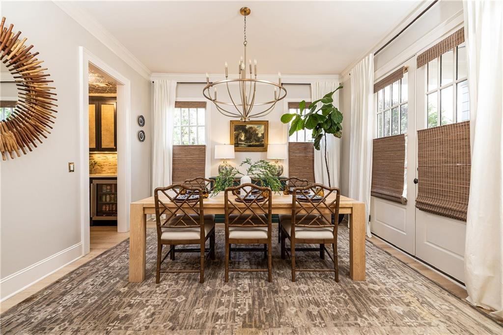 6810 Lullwater Road Cumming, GA 30040 - Photo 5 of 63 a dining room with furniture a chandelier and window
