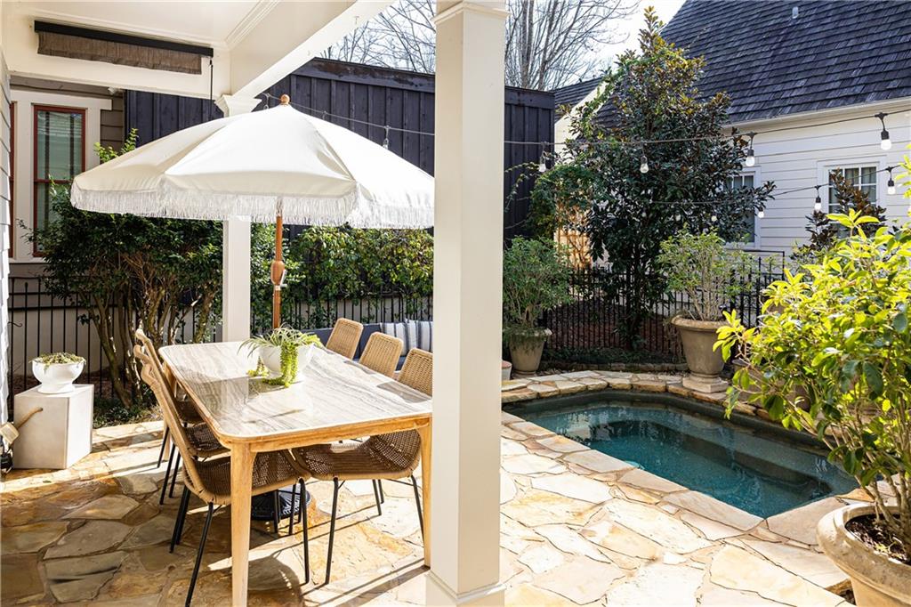 6810 Lullwater Road Cumming, GA 30040 - Photo 53 of 63 a view of a patio with table and chairs under an umbrella