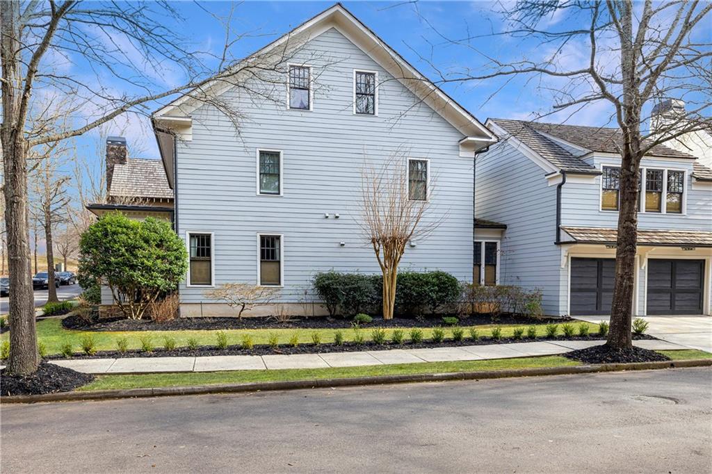 6810 Lullwater Road Cumming, GA 30040 - Photo 56 of 63 a front view of house with yard and green space