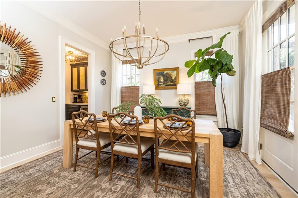 6810 Lullwater Road Cumming, GA 30040 - Photo 6 of 63 a view of a dining room with furniture window and wooden floor
