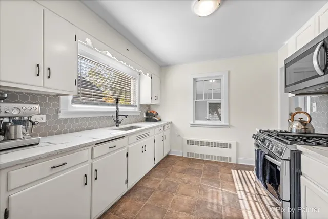 a kitchen with sink stove and cabinets