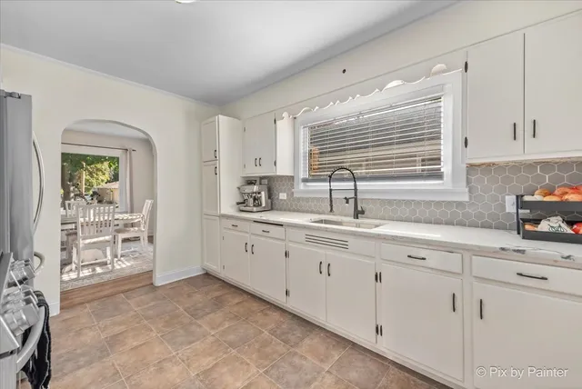 a kitchen with sink and cabinets