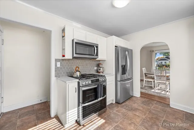 a kitchen with stainless steel appliances a stove a microwave and a refrigerator