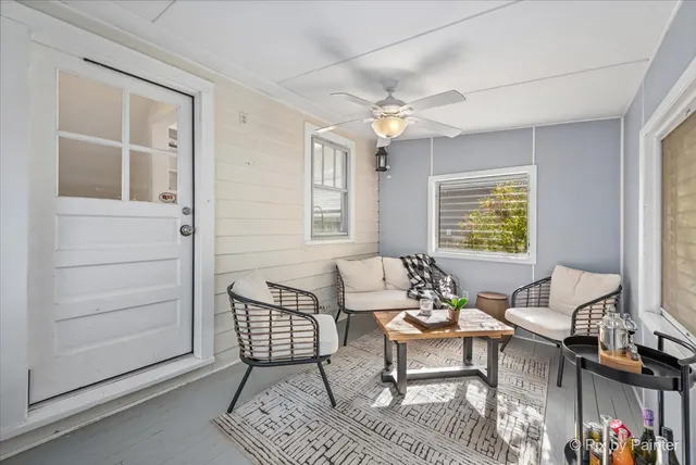 a living room with furniture a chandelier and a window
