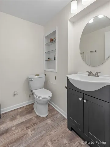 a bathroom with a sink toilet and a mirror