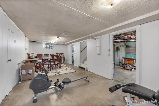 a front view of a house with a yard and potted plants