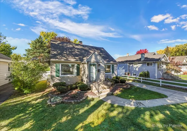 a view of a house with wooden fence