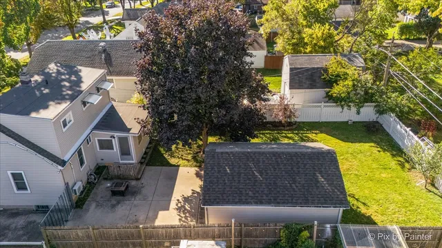 an aerial view of a house with a yard