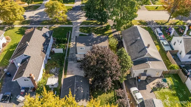 an aerial view of a house with a yard