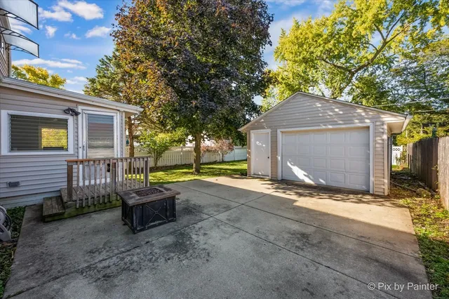 a view of a house with backyard and a tree