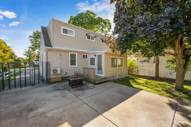 a backyard of a house with a large tree