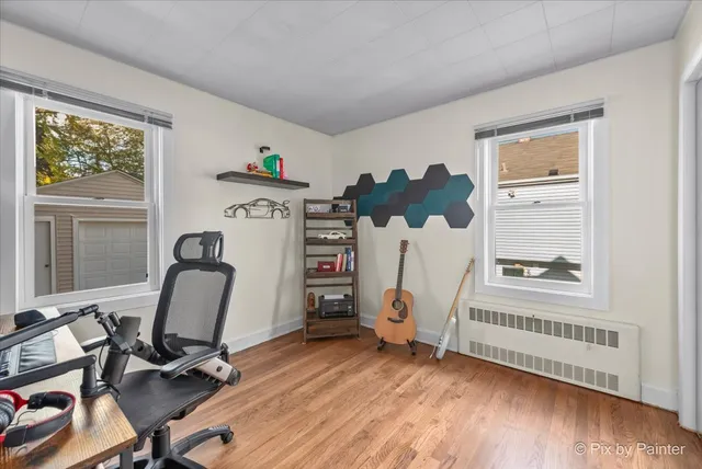 a view of a workspace with furniture and a window