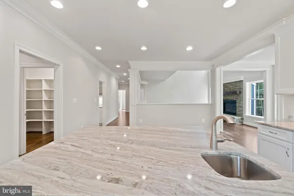 a kitchen with kitchen island a sink stainless steel appliances and cabinets