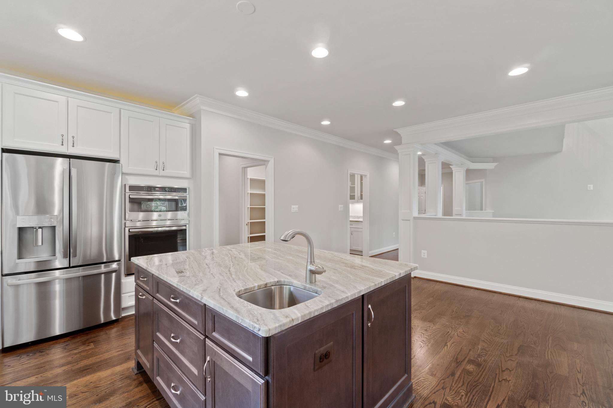13741 Orlando Road Nokesville, VA 20181 - Photo 19 of 41 a kitchen with kitchen island a sink stainless steel appliances and cabinets