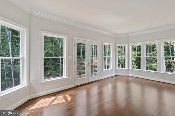 wooden floor in an empty room with stairs