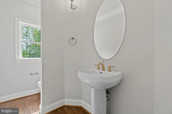 a bathroom with a sink a mirror and a toilet