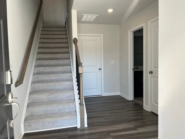 a view of an entryway with wooden floor