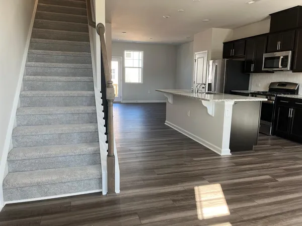 a view of kitchen with cabinets and wooden floor