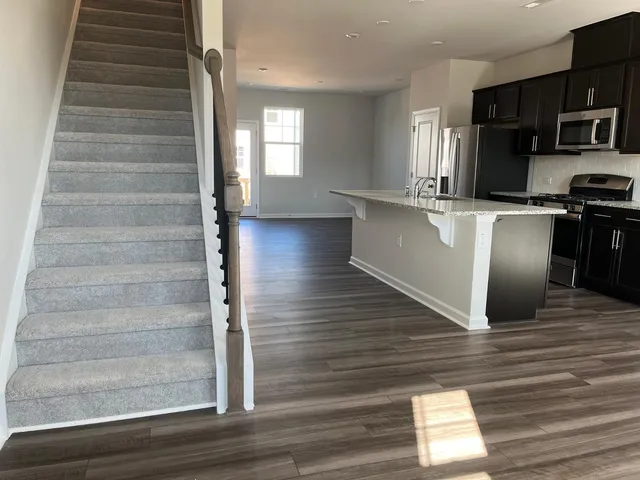 a view of kitchen with cabinets and wooden floor