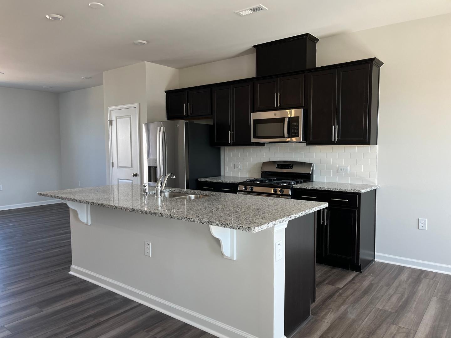 1918 Rosedale Rdg Avenue Wake Forest, NC 27587 - Photo 6 of 18 a kitchen with a sink and a microwave