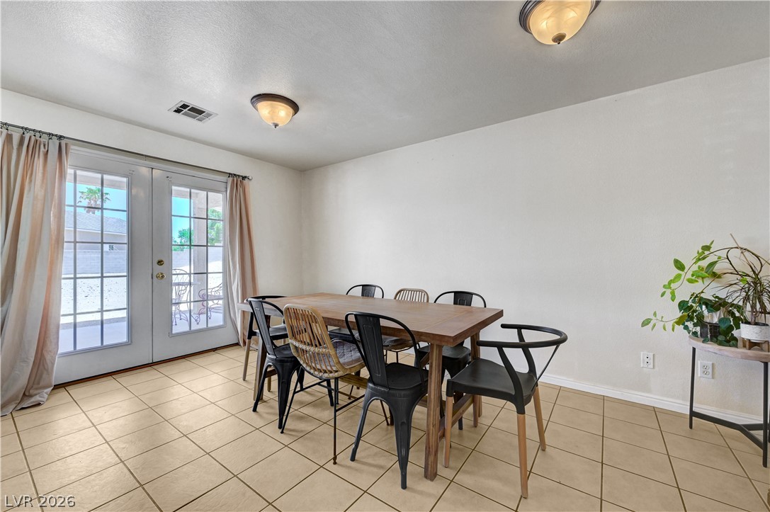 1272 Liston Avenue Logandale, NV 89021 - Photo 15 of 61 French doors open to an outdoor patio from this versatile dining area.