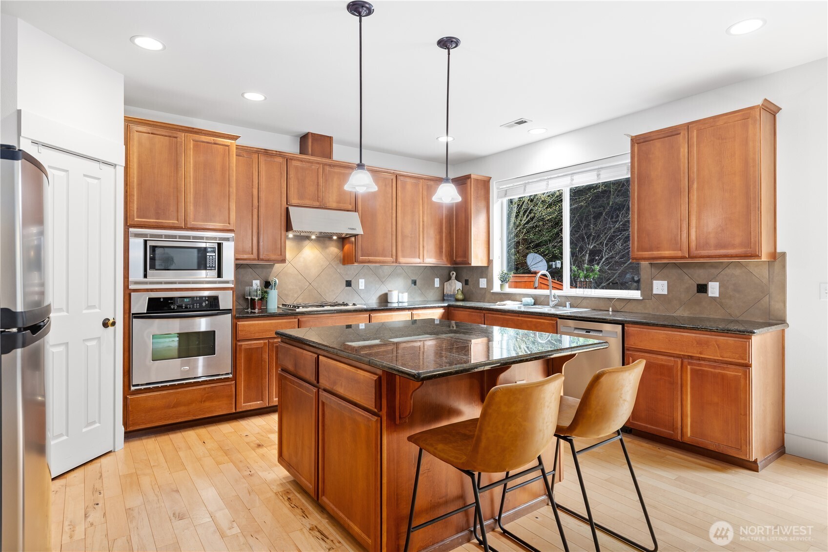 22829 36th Avenue Southeast Bothell, WA 98021 - Photo 11 of 39 a kitchen with stainless steel appliances granite countertop a sink a stove and a refrigerator