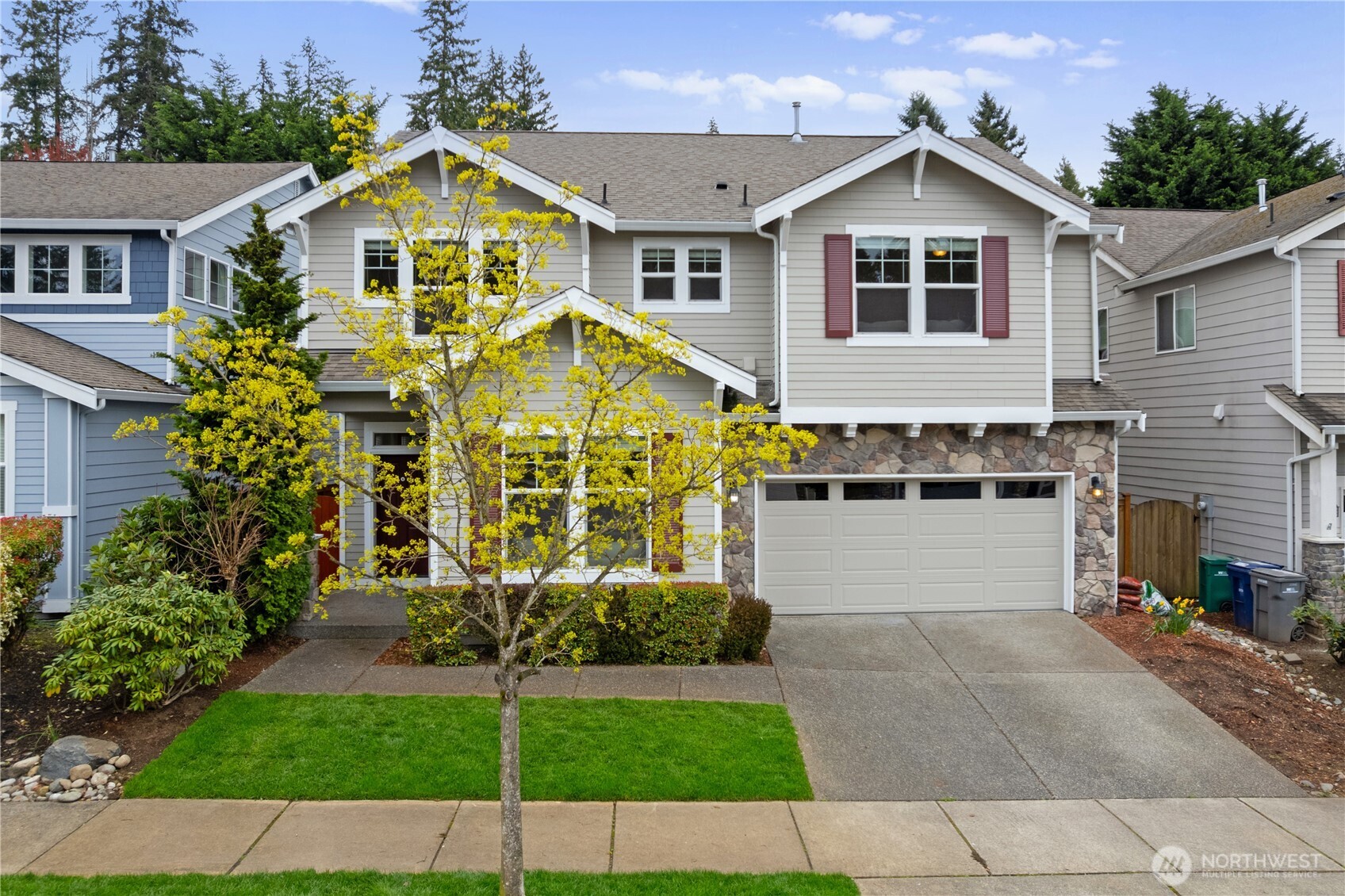 22829 36th Avenue Southeast Bothell, WA 98021 - Photo 3 of 39 a view of a white house with large windows and a yard