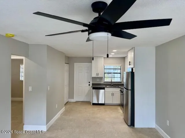 a kitchen with stainless steel appliances kitchen island a refrigerator and a stove top oven
