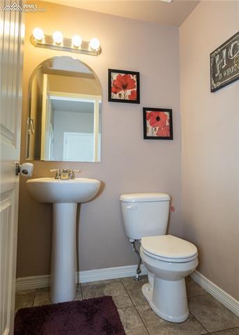 2105 Reed Grass Way Colorado Springs, CO 80915 - Photo 3 of 23 Half-bath with pedestal sink and ceramic tile.