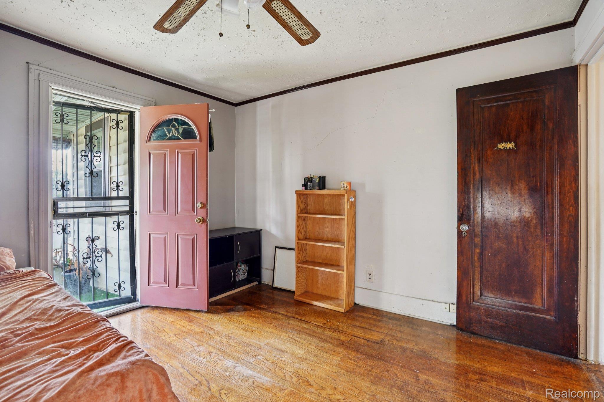 4101 Pasadena Street Detroit, MI 48238 - Photo 30 of 42 Wood-finish flooring, ceiling fan, solid wood interior door, front entry door with decorative glass insert, and security screen door