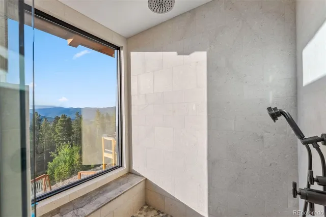 a view of a room that has a large window and a sliding door