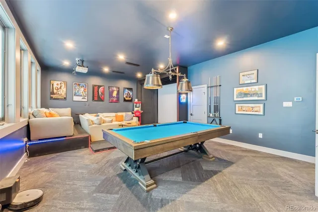 a room with furniture pool table and windows