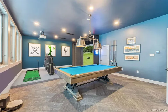 a room with pool table and windows