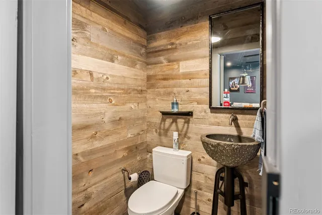 a bathroom with a toilet a sink and mirror