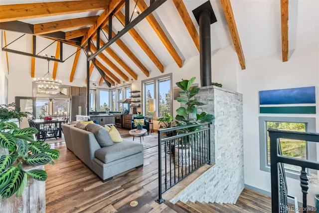 a bedroom with a large bed and a flat tv screen on dresser