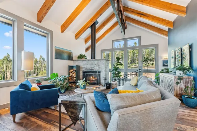 a living room with furniture a fireplace and a large window