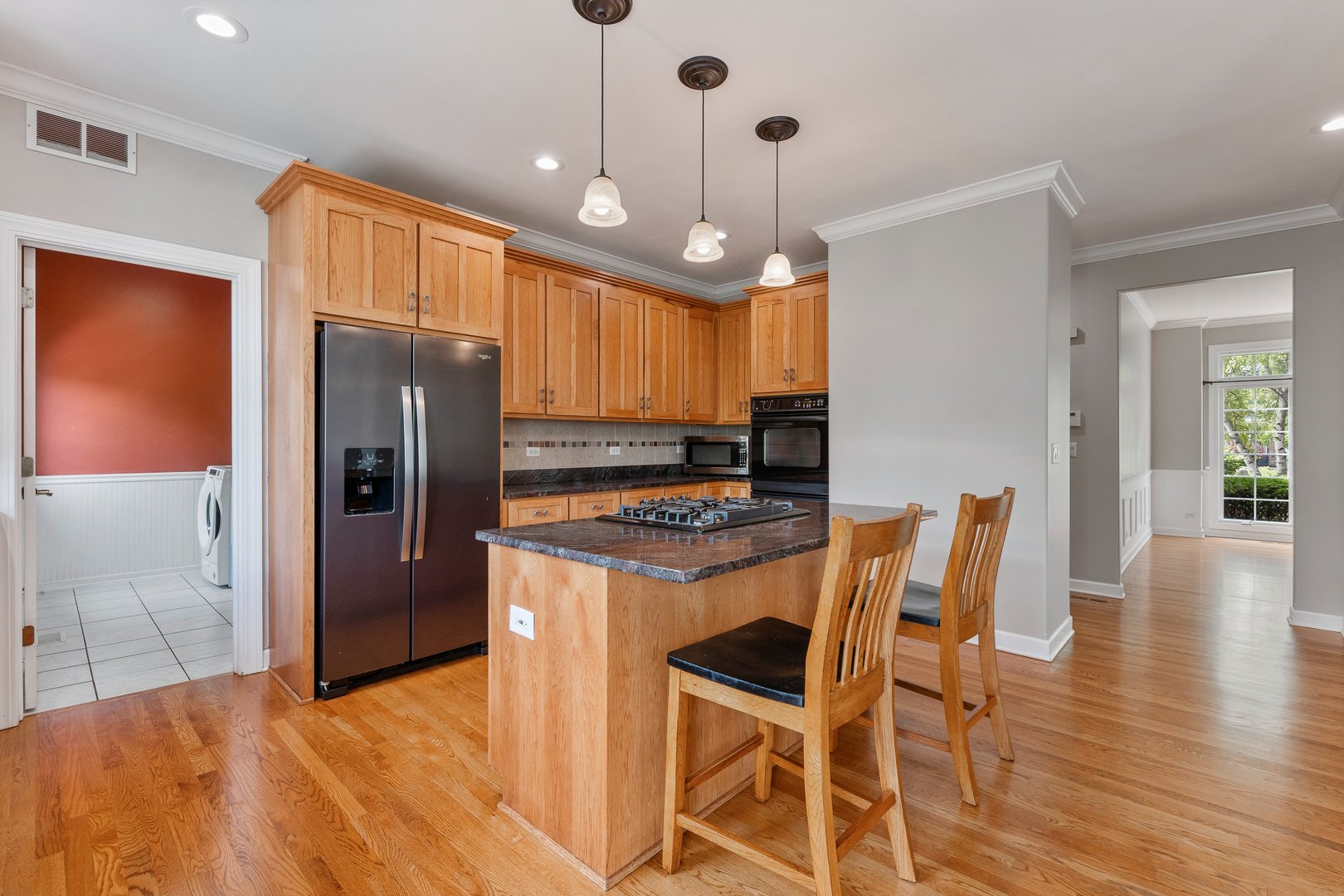 2531 Spartina Road Naperville, IL 60564 - Photo 2 of 39 a kitchen with stainless steel appliances kitchen island granite countertop a table chairs and a refrigerator