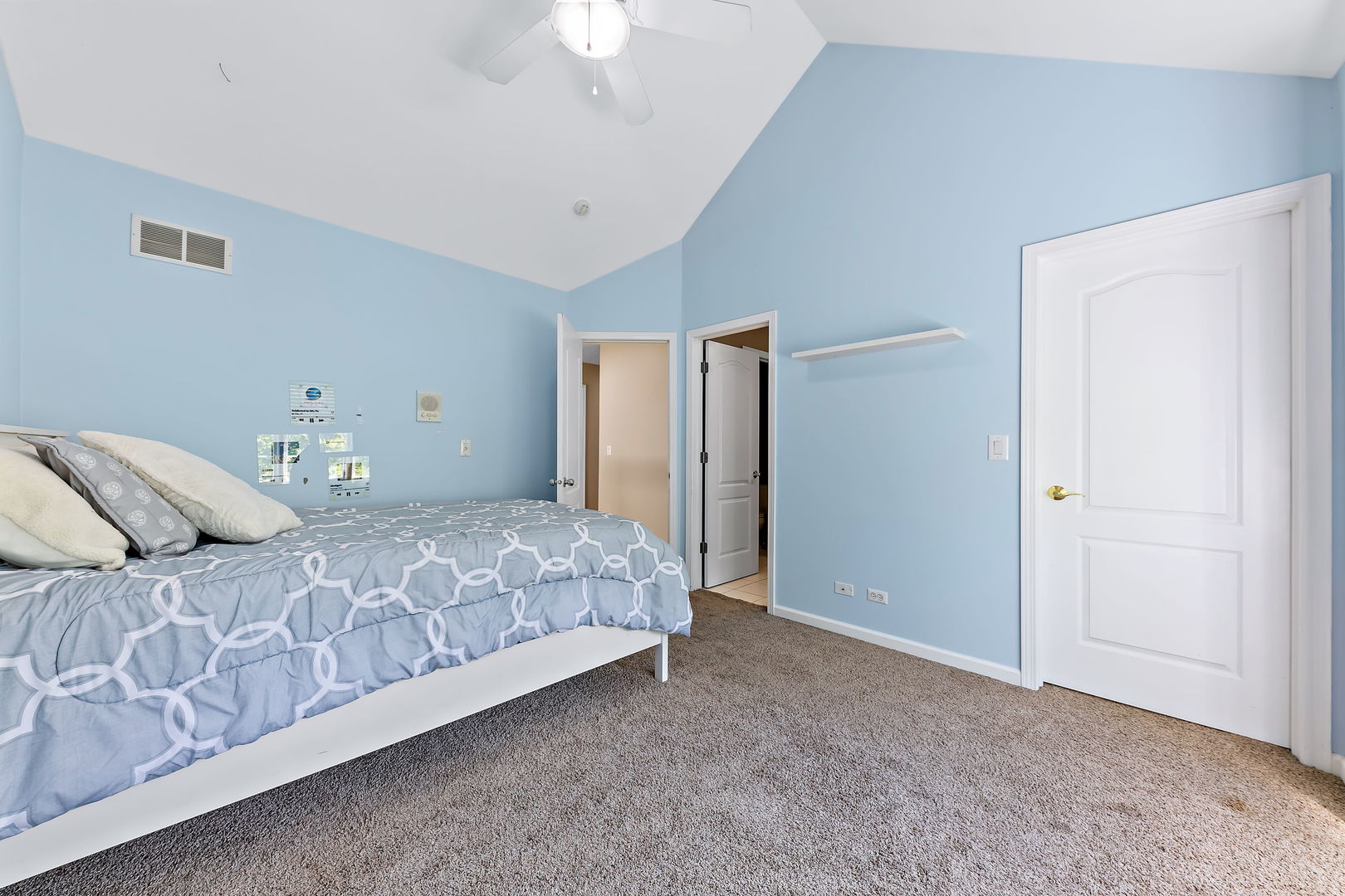 2531 Spartina Road Naperville, IL 60564 - Photo 21 of 39 a bedroom with a large bed and a chandelier