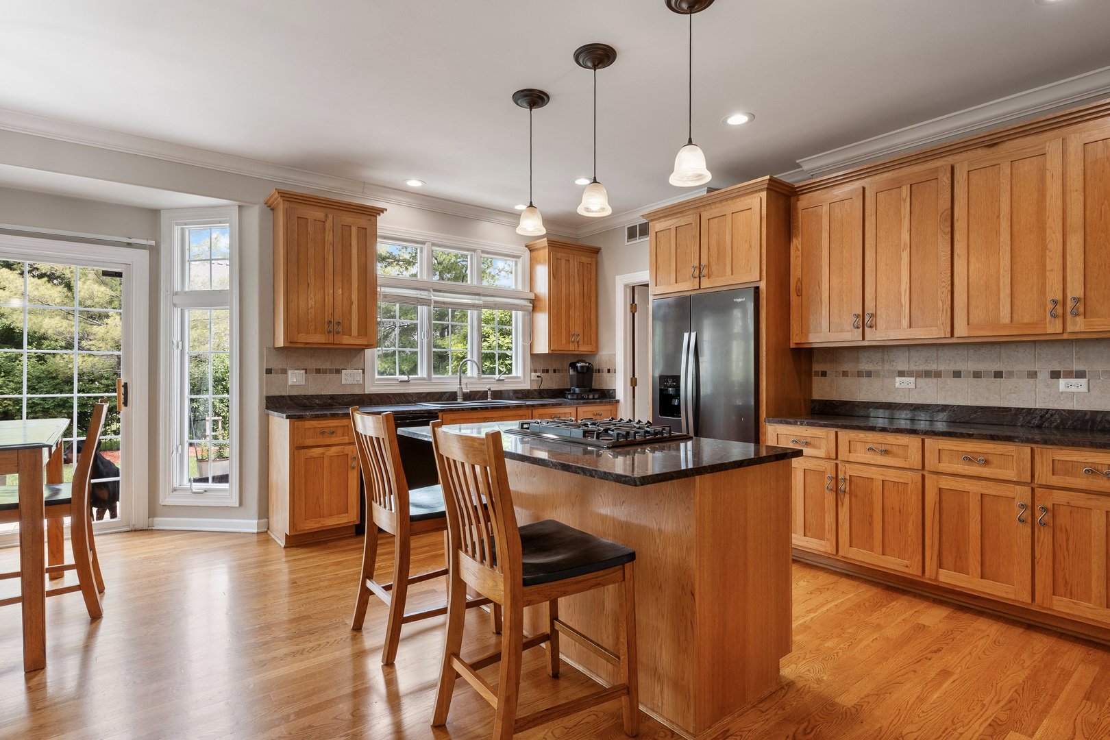 2531 Spartina Road Naperville, IL 60564 - Photo 4 of 39 a kitchen with stainless steel appliances granite countertop wooden floor window and refrigerator
