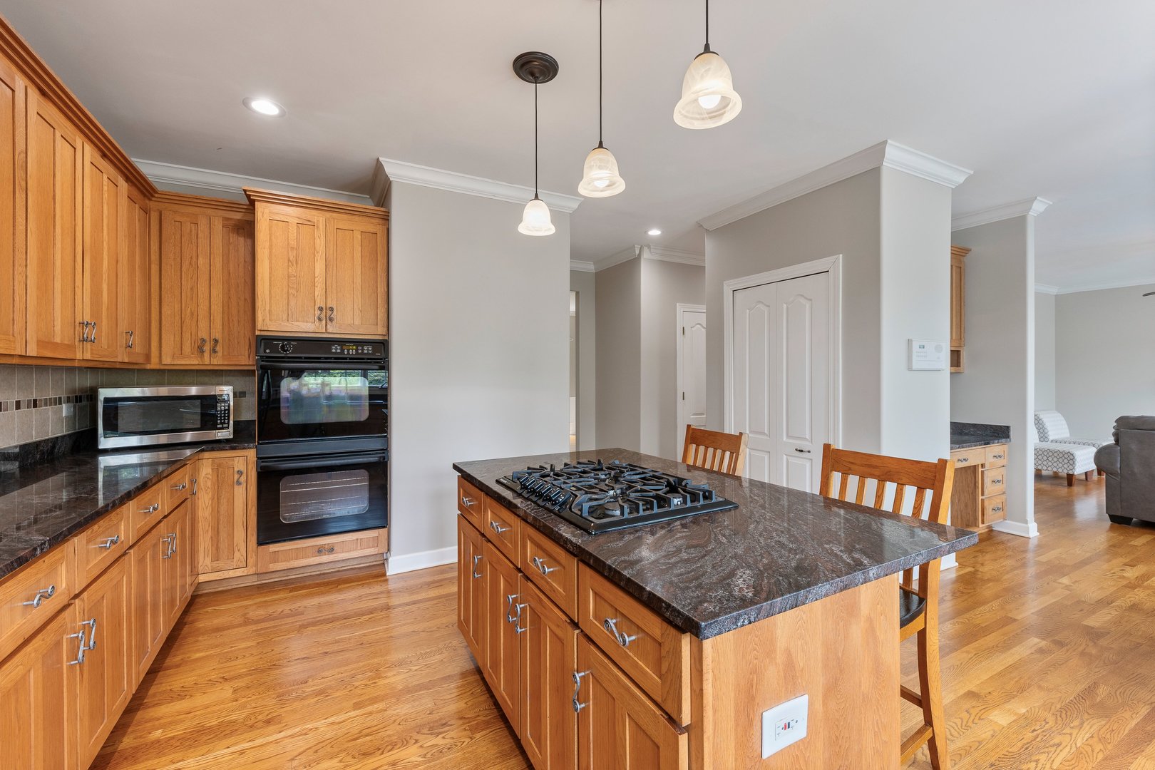 2531 Spartina Road Naperville, IL 60564 - Photo 6 of 39 a kitchen with a stove a sink a kitchen island with wooden cabinets and floor