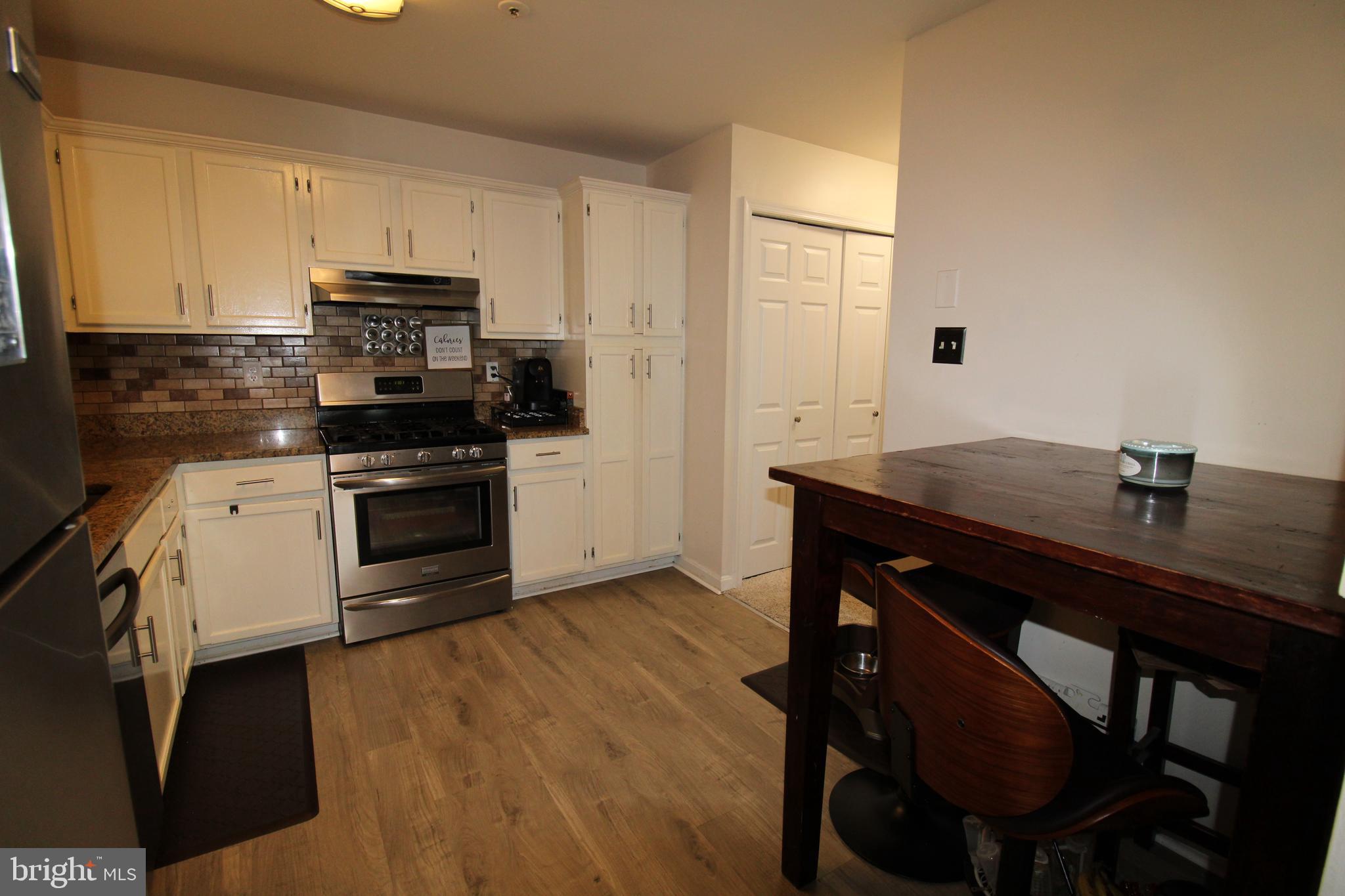 7863 Apache Ridge Court Manassas, VA 20109 - Photo 11 of 38 a kitchen with a sink cabinets and wooden floor